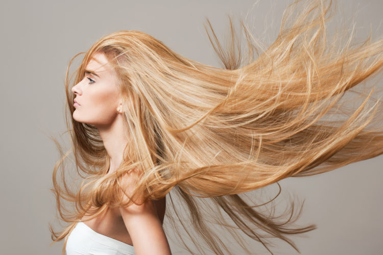 Portrait of a blond beauty with beautiful healthy long hair.